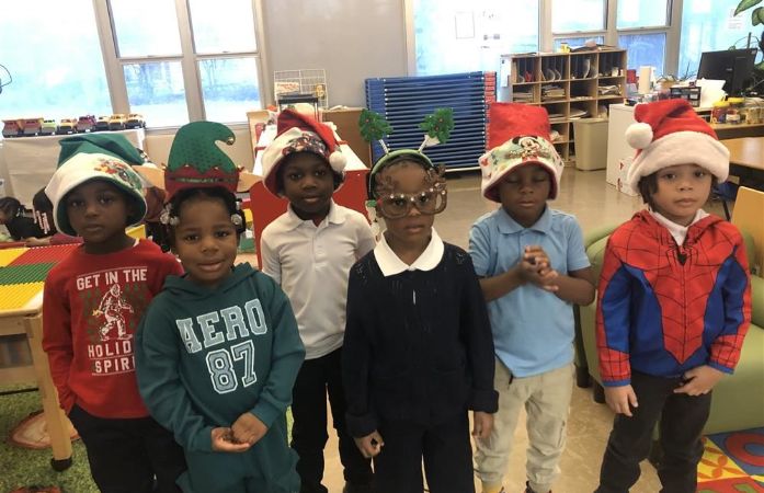  6 students wearing Santa hats